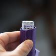 A hand holding an Advair Diskus inhaler, a medication used for asthma. A hand holding an Advair Diskus inhaler, a medication used for asthma.