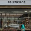 A person walks past a Balenciaga store closed with metal grilles, reflecting the brand's current controversies. A person walks past a Balenciaga store closed with metal grilles, reflecting the brand's current controversies.