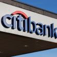 Citibank signage on a building against a clear blue sky. Citibank signage on a building against a clear blue sky.