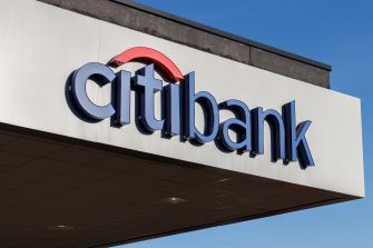 Citibank signage on a building against a clear blue sky.