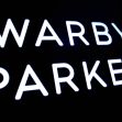 Signage displaying the name "Warby Parker." Signage displaying the name "Warby Parker."