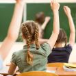 Students raising their hands in a classroom setting. Students raising their hands in a classroom setting.