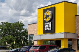 Exterior view of a Buffalo Wild Wings restaurant with a bright yellow facade and logo.