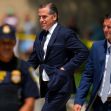 Hunter Biden walking with security personnel amidst ongoing legal issues. Hunter Biden walking with security personnel amidst ongoing legal issues.