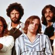 Image of a rock band from the 1970s, featuring five male musicians posing for a group photo. Image of a rock band from the 1970s, featuring five male musicians posing for a group photo.