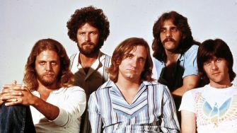 Image of a rock band from the 1970s, featuring five male musicians posing for a group photo.