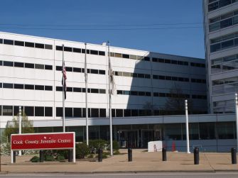 Exterior view of the Cook County Juvenile Center with flags flying.