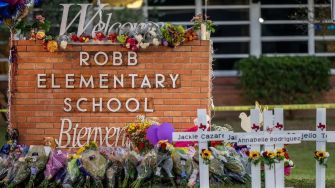 Memorial setup with flowers and crosses for the victims of the Robb Elementary School shooting in Uvalde, Texas.