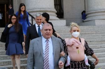 A group of individuals, including Lev Parnas, exiting a courthouse following a trial related to campaign finance law violations.