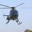 A police helicopter in flight, relevant to a legal case involving the aiming of a laser pointer at an aircraft. A police helicopter in flight, relevant to a legal case involving the aiming of a laser pointer at an aircraft.