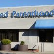 Exterior view of a Planned Parenthood facility with signage. Exterior view of a Planned Parenthood facility with signage.