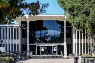 Exterior view of Pomona City Hall with trees in the foreground.