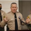 Los Angeles County Sheriff Alex Villanueva speaking at a press conference, with deputies in the background. Los Angeles County Sheriff Alex Villanueva speaking at a press conference, with deputies in the background.