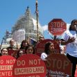 Protesters from the San Carlos Apache tribe holding signs opposing copper mining on sacred land at a demonstration. Protesters from the San Carlos Apache tribe holding signs opposing copper mining on sacred land at a demonstration.