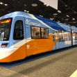 A brightly colored OC Streetcar model displayed at a transit show. A brightly colored OC Streetcar model displayed at a transit show.