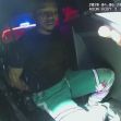 A man sitting in the back of a police car during a traffic stop. A man sitting in the back of a police car during a traffic stop.