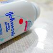 A container of Johnson's Baby Powder on a surface, highlighting its branding. A container of Johnson's Baby Powder on a surface, highlighting its branding.
