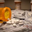 Image of scattered prescription pill bottles and white tablets lying on a surface covered with U.S. currency. Image of scattered prescription pill bottles and white tablets lying on a surface covered with U.S. currency.