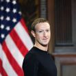 Mark Zuckerberg standing in front of an American flag. Mark Zuckerberg standing in front of an American flag.