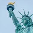 Statue of Liberty holding a torch against a clear sky. Statue of Liberty holding a torch against a clear sky.