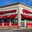 CVS pharmacy storefront with red signage and awnings under a blue sky. CVS pharmacy storefront with red signage and awnings under a blue sky.