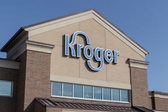 Kroger store exterior sign against a clear blue sky.