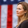 Judge Amy Coney Barrett standing in front of an American flag. Judge Amy Coney Barrett standing in front of an American flag.