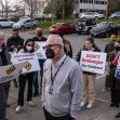 A group of protesters holding signs expressing concerns about the safety of children in relation to a new housing project for the homeless in front of a hotel in Kirkland, Washington. A group of protesters holding signs expressing concerns about the safety of children in relation to a new housing project for the homeless in front of a hotel in Kirkland, Washington.