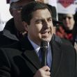 Wisconsin Attorney General Joshua Kaul speaking at a public event, holding a microphone and addressing a crowd. Wisconsin Attorney General Joshua Kaul speaking at a public event, holding a microphone and addressing a crowd.