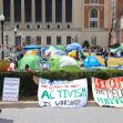 Tents and protest signs set up on a university campus during a pro-Palestinian protest. Tents and protest signs set up on a university campus during a pro-Palestinian protest.