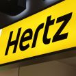 Hertz rental car logo displayed at an airport location. Hertz rental car logo displayed at an airport location.