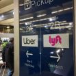 Sign for Uber and Lyft pickup locations at an airport, indicating different waiting areas for the ride-sharing services. Sign for Uber and Lyft pickup locations at an airport, indicating different waiting areas for the ride-sharing services.