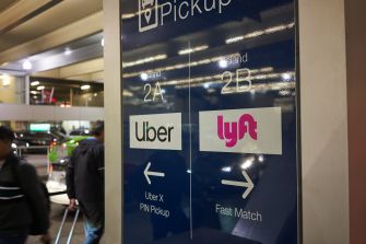 Sign for Uber and Lyft pickup locations at an airport, indicating different waiting areas for the ride-sharing services.