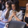 Four gymnasts sitting in a Senate hearing audience, conveying emotions of concern and contemplation. Four gymnasts sitting in a Senate hearing audience, conveying emotions of concern and contemplation.