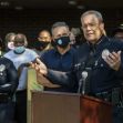 A police official speaks at a podium during a public event, with officers and community members present in the background. A police official speaks at a podium during a public event, with officers and community members present in the background.