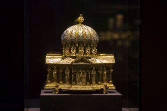 Gilded ecclesiastical relic, part of the Welfenschatz collection, displayed in a museum.