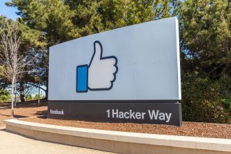 Sign outside Facebook's headquarters at 1 Hacker Way with a thumbs-up logo.
