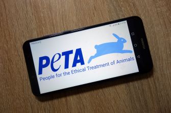 Logo of PETA (People for the Ethical Treatment of Animals) displayed on a smartphone screen.