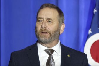 Ohio Attorney General Dave Yost speaking at a press conference regarding lawsuits against two car dealerships for consumer protection law violations.