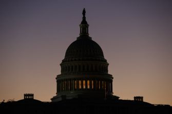 Silhouette of the U.S. Capitol building at sunset.