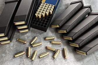 Various ammunition magazines and bullets scattered on a surface.