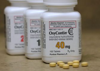 Purdue Pharma's OxyContin bottles and pills, symbolizing the opioid crisis and recent Supreme Court ruling on bankruptcy settlement.