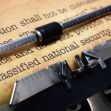 Close-up of a typewriter with a sheet of paper that has text related to classified national security information. Close-up of a typewriter with a sheet of paper that has text related to classified national security information.