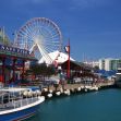 View of Navy Pier in Chicago, featuring the waterfront, the iconic Ferris wheel, and recreational boats. View of Navy Pier in Chicago, featuring the waterfront, the iconic Ferris wheel, and recreational boats.