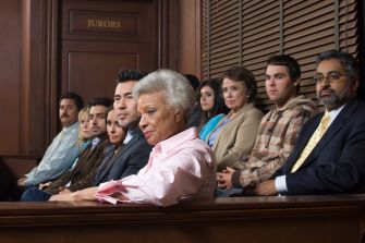 Jury members seated in a courtroom during a trial.
