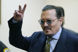 Johnny Depp gesturing peace sign during his defamation trial.