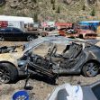 A severely damaged Tesla Model 3, burnt and wrecked, in a salvage yard after a fatal crash. A severely damaged Tesla Model 3, burnt and wrecked, in a salvage yard after a fatal crash.