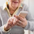 An elderly woman using a smartphone, illustrating the target demographic in a telemarketing fraud case. An elderly woman using a smartphone, illustrating the target demographic in a telemarketing fraud case.