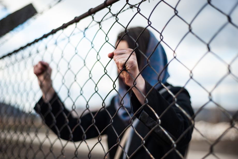 Detained immigrant behind fence