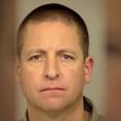 Mugshot of a man with short hair and a neutral expression. Mugshot of a man with short hair and a neutral expression.